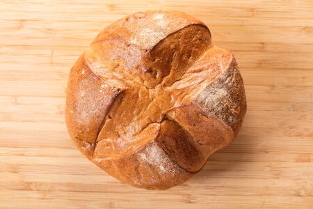 round bread close-up on a wooden background in rustic style