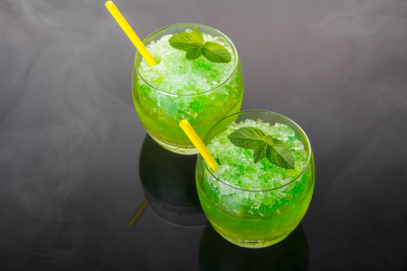 Cocktail alcoholic mojito from ice on a black backgroundの写真素材
