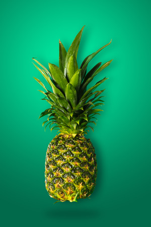 ripe organic pineapple close-up on a green backgroundの写真素材