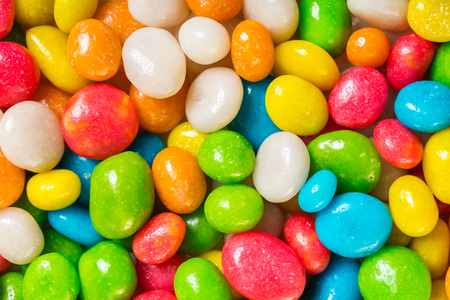 food background of round candy in multicolored glazeの写真素材