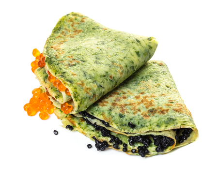 pancakes with spinach filling red and black caviar on white isolated backgroundの写真素材