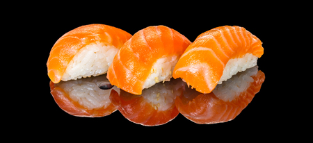 Japanese food, sushi with salmon on black backgroundの写真素材