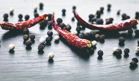 food background dry spicy and fragrant peppers close-up on blackの写真素材