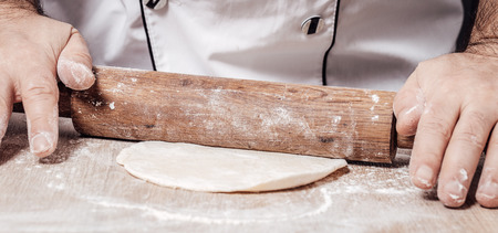 male chef kneads the dough, hands closeupの写真素材