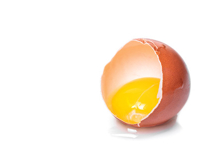 broken chicken egg on white isolated background