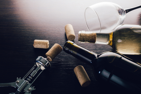 bottles of wine and corkscrew on wooden backgroundの写真素材