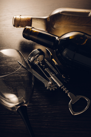 bottles of wine and corkscrew on wooden backgroundの写真素材