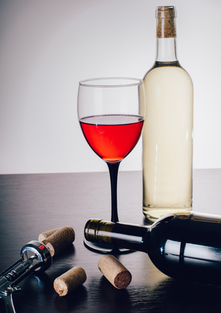 white and red wine on a wooden tableの写真素材