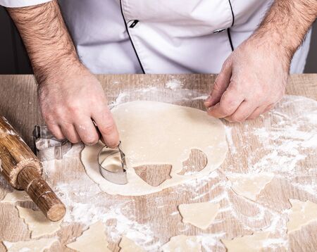 male cook preparing Christmas cookies, hands close-upの写真素材