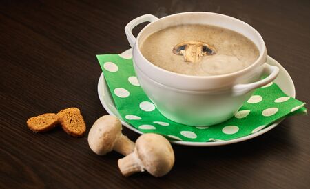 Cream of mushroom soup on wooden background                               の写真素材