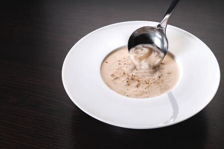 onion cream soup on a wooden backgroundの写真素材