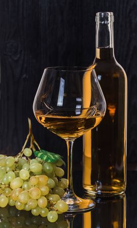 alcohol, white wine with green grapes on a black backgroundの写真素材