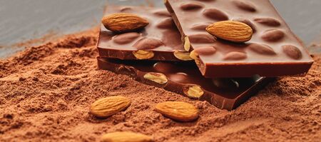 chocolate bar on a background of cocoa powder                               