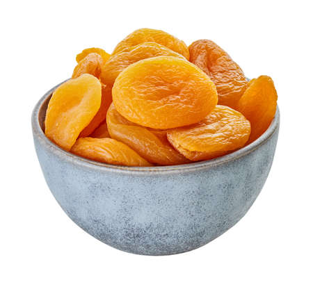 dried apricots in bowl on a white isolated backgroundの写真素材