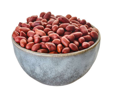 raw peanuts in bowl close-up on a white isolated background