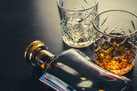 alcoholic drink, whiskey on brown wooden backgroundの写真素材