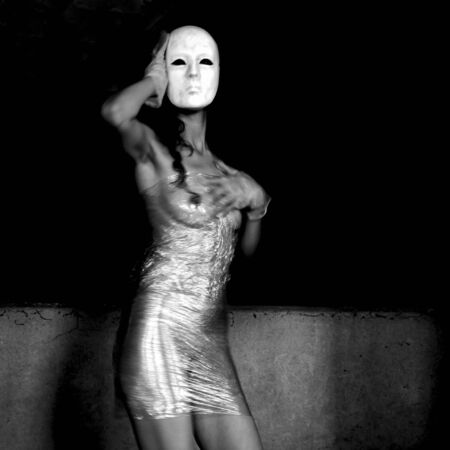Naked and masked dancer wrapped in cellophane transparentの写真素材