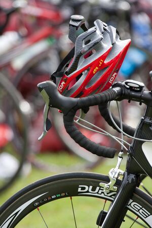 AUCH, FRANCE,  SEPTEMBER 4, 2010: Auch triathlon, red helmet  in the transition area , on  September 4th, 2010, in Auch, France.のeditorial素材