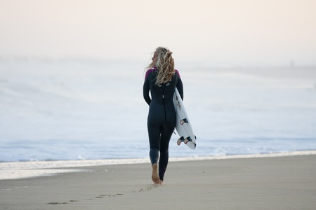 SEIGNOSSE, FRANCE - JUNE 3, 2011: attractive surfer walking on the beach early in the morning at the Swatch Pro France on June 3, 2011, in Seignosse , France.のeditorial素材