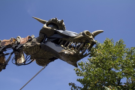 AURILLAC, FRANCE- AUGUST 18: A dragon eats some leaves in the street at  the Aurillac International Street Theater Festival, Cie " Planete vapeur" on August 18, 2011 in Aurillac, France. のeditorial素材