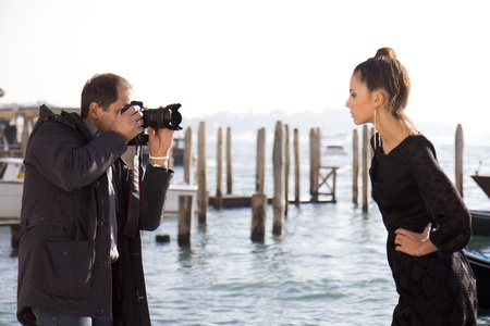 VENICE, ITALY - NOVEMBER 27:  An unidentified photographer take pictures of a female model on the Riva degli Schiavone between the Doges Palace and the lagoon, on November 27, 2011, in Venice, Italy.のeditorial素材