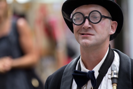 AURILLAC, FRANCE - AUGUST 23: musician  wearing round glasses as part of the Aurillac International Street Theater Festival, Company Histoire de famille ,on august 23, 2012, in Aurillac,France. のeditorial素材