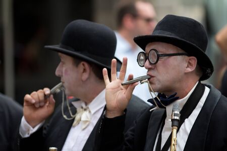 AURILLAC, FRANCE - AUGUST 23: musicians blowing in a whistle as part of the Aurillac International Street Theater Festival, Company Histoire de famille ,on august 23, 2012, in Aurillac,France. のeditorial素材