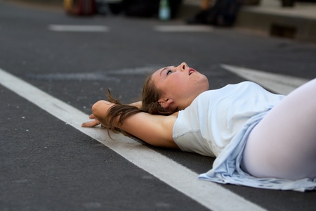 AURILLAC, FRANCE - AUGUST 22: a young woman is lying down in the street as part of the Aurillac...
