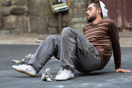 AURILLAC, FRANCE - AUGUST 24:a masked man sits down in the street as part of the Aurillac International Street Theater Festival,show by the Company Idem,on august 24, 2012, in Aurillac,France.のeditorial素材