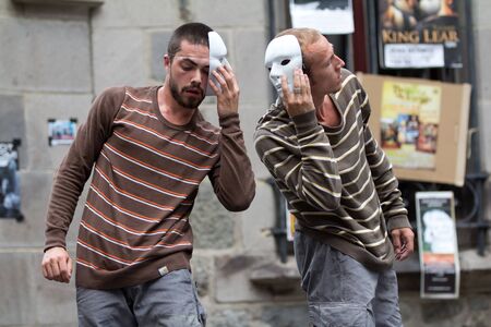 AURILLAC, FRANCE - AUGUST 24: two masked dancers, side to side, as part of the Aurillac International Street Theater Festival,show by the Company Idem,on august 24, 2012, in Aurillac,France.のeditorial素材