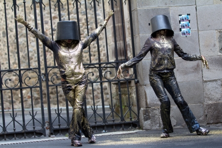 AURILLAC, FRANCE - AUGUST 23: Two women dance with a bucket on the head as part of the Aurillac International Street Theater Festival, show named Vachement, on august 23, 2012, in Aurillac,France.のeditorial素材