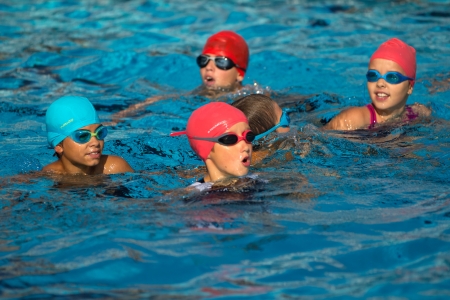 AUCH, FRANCE - SEPTEMBER 8: some unidentified young triathletes are waiting for the start,n the swimming pool, Auch Triathlon for children, on September 8, 2012 in Auch, France.のeditorial素材