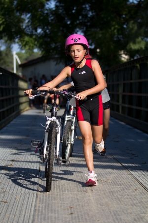 AUCH, FRANCE - SEPTEMBER 8: an unidentified young female runner in the transition area, Auch Triathlon for children, on September 8, 2012 in Auch, France.のeditorial素材