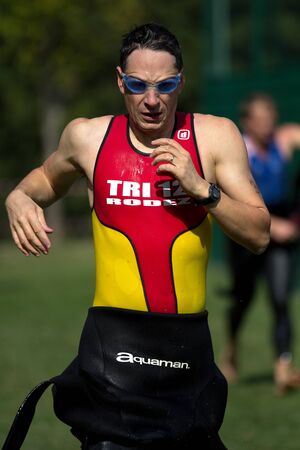AUCH, FRANCE - SEPTEMBER 8: an unidentified male runner in the transition area after the swim race, Auch Triathlon, on September 8, 2012 in Auch, France.のeditorial素材