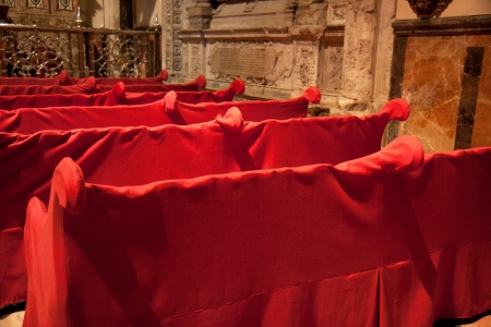 Red sheets on the benches of a chapel of the cathedral of Seville, Andalusia, spain の写真素材