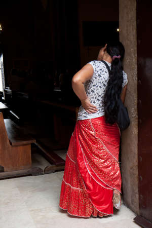 CORDOBA, SPAIN - OCTOBER 11: Rear view of a bohemian woman at the entrance of a church on October 11 , 2012,  in Cordoba, Spain.のeditorial素材