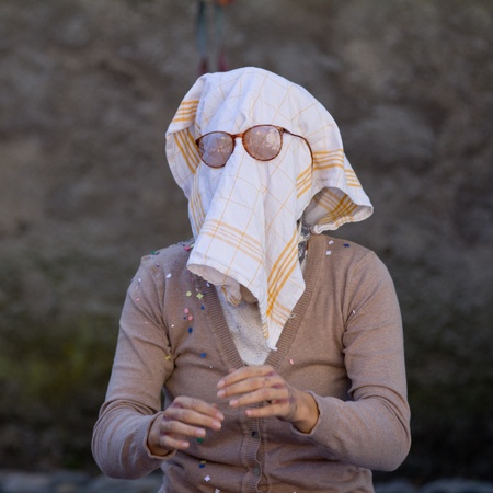 AURILLAC, FRANCE - AUGUST 21 an old woman wears a dish towel on the face as part of the Aurillac International Street Theater Festival, Company L arbre à vache ,on august 21, 2013, in Aurillac,France のeditorial素材