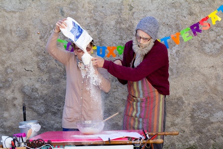 AURILLAC, FRANCE - AUGUST 21  a funny elderly couple is making a cake as part of the Aurillac International Street Theater Festival, Company L arbre à vache ,on august 21, 2013, in Aurillac,France のeditorial素材