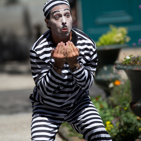 AURILLAC, FRANCE - AUGUST 21  handcuffed clown in the street as part of the Aurillac International Street Theater Festival, Company Les hommes papillon,on august 21, 2013, in Aurillac,France のeditorial素材