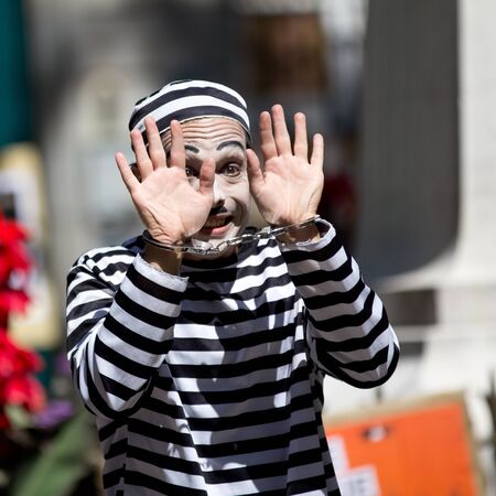 AURILLAC, FRANCE - AUGUST 21  a clown shows his handcuffed hands as part of the Aurillac International Street Theater Festival, Company Les hommes papillon,on august 21, 2013, in Aurillac,France のeditorial素材
