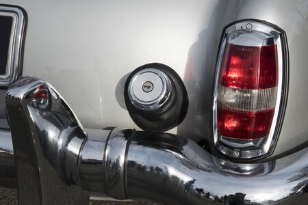 AUCH, FRANCE - MARCH 10, 2019: The old cars: Chromium covers taillight, gas cap top, and rear...
