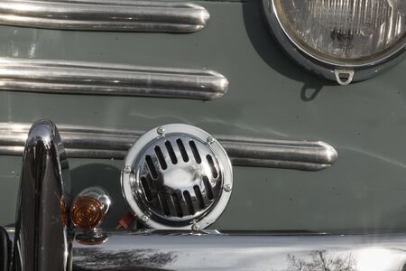 AUCH, FRANCE - MARCH 10, 2019: The old cars: Close-up of the grill of the Renault 4CV a mythic french car. Chromium covers a part of the headlight, the horn.のeditorial素材