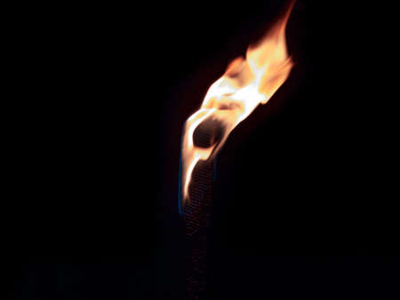 Burning torch on dark background at night.の写真素材