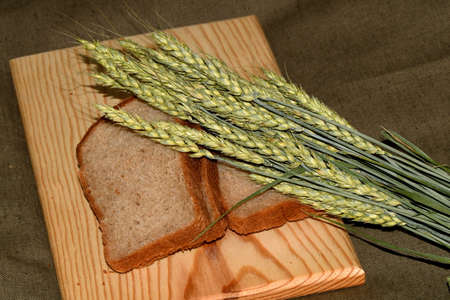 sliced bread and wheat earsの写真素材