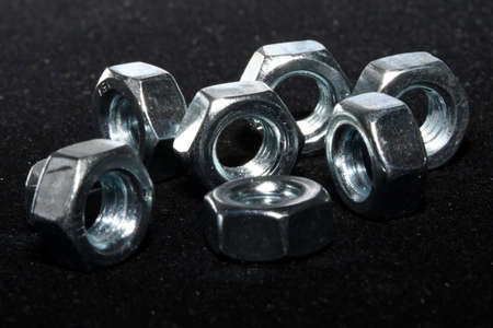 metal nuts on a black background