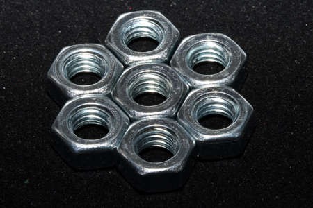 metal nuts on a black background