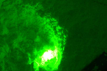 the green light of the laser is reflected from the powder
