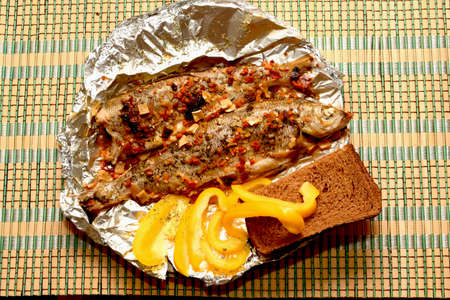 fish baked on foil and vegetablesの写真素材