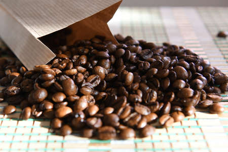 coffee beans are poured out of the bagの写真素材
