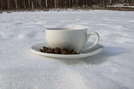 a cup of coffee in the snowの写真素材